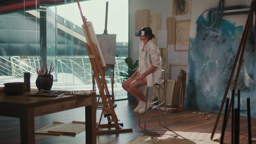 A Artist Paints in Virtual Reality Using Virtual Reality Goggles, Exploring New Frontiers in Creativity and Innovation. Concept of Art Creation in Virtual Reality Merging Traditional Skills with
