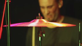 Drumstick striking cymbal by professional drummer under variable lighting on stage. - Powered by Shutterstock - Get 15% off with code: PIKWIZARD15