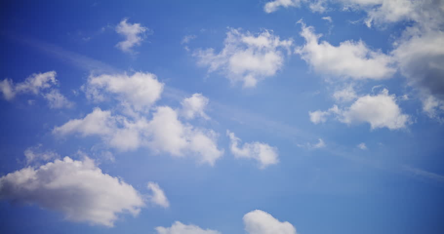 Timelapse of beautiful white clouds gently moving across a bright blue sky, heralding a sunny spring day.