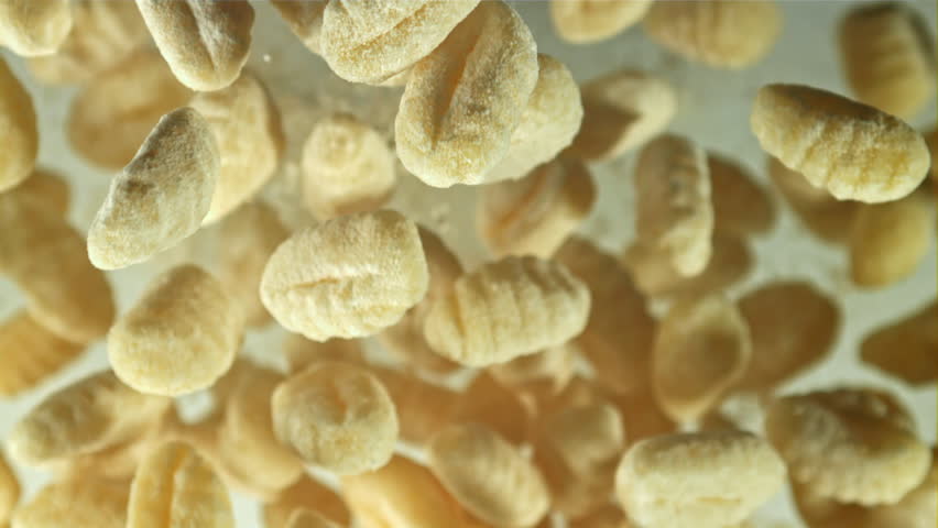 Gnocchi fly up and fall down. Filmed on a high-speed camera at 1000 fps. High quality FullHD footage