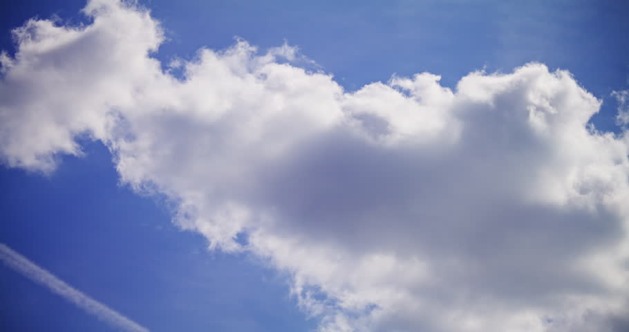 Time-lapse of beautiful spring clouds moving across a blue sky, heralding a sunny day.