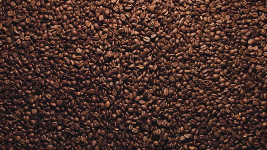 Dynamic stock footage featuring a creative reveal of the map of Ireland. Formed entirely from rich brown coffee beans. The beans part like the sea, unveiling the shape of the Emerald Isle beneath.