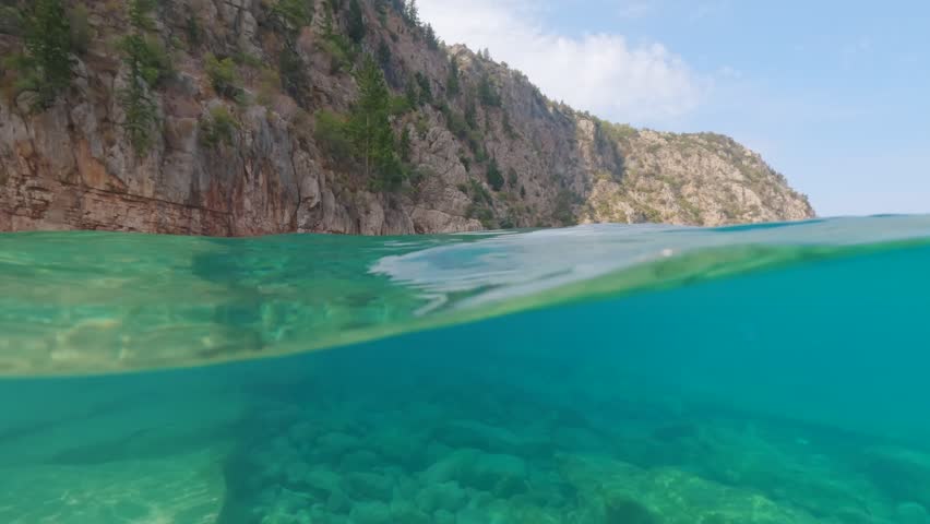 Landscape and sea at Butterfly Valley near Oludeniz, split video half underwater