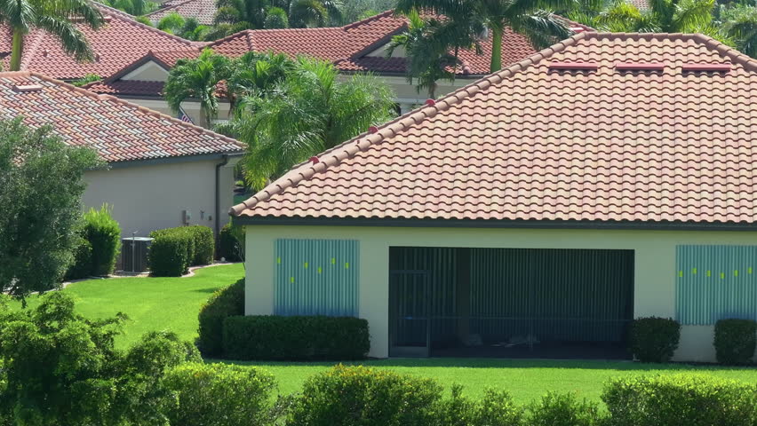 Storm shutters mounted on Florida house windows for hurricane protection. Preparing for natural disaster