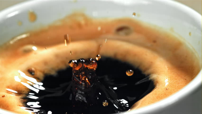 Falling drop in a cup of coffee. Filmed on a high-speed camera at 1000 fps. High quality FullHD footage