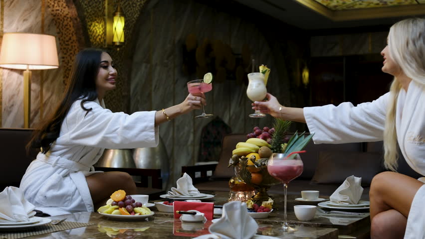 Women in swimwear relax inside a sauna, enjoying a tranquil and therapeutic experience, enhancing their overall wellness and bonding in an intimate setting