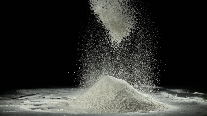 The flour is sifted through a sieve. On a black background. Filmed on a high-speed camera at 1000 fps. High quality FullHD footage