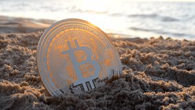 Bitcoin BTS coin in sand near sea waves on sandy beach of sea coast at dawn sunset close-up. Cryptocurrency money cryptography cryptocurrencies bitcoins crypto-currencies concept. Peer-to-peer payment - Powered by Shutterstock - Get 15% off with code: PIKWIZARD15