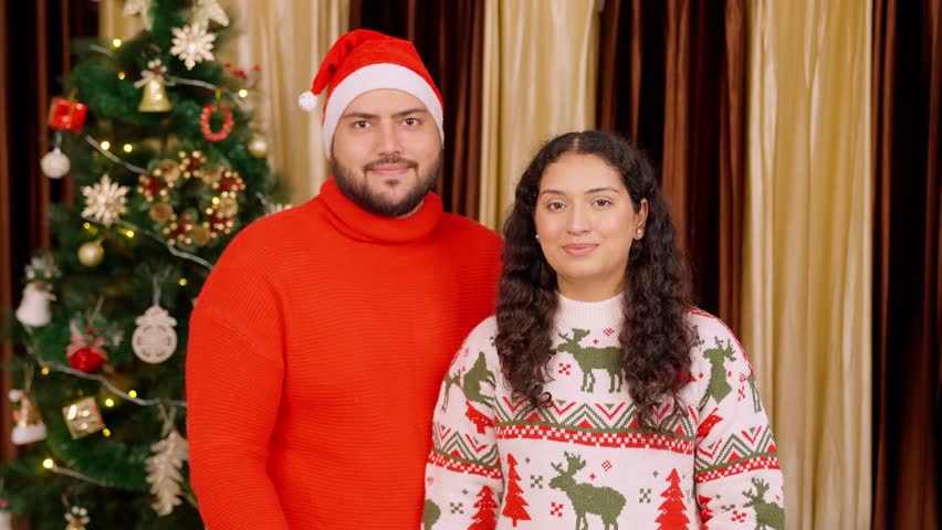 Indian Couple Holding Thanksgiving Poster with Christmas Tree in background