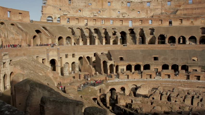 Tourists visiting the interior of the colosseum in rome