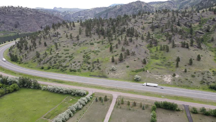 Drone Aerial camera flying along Montana in the Summer, Country Road, Wilderness