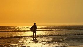 Surfer running into ocean waves at golden hour - Powered by Shutterstock - Get 15% off with code: PIKWIZARD15