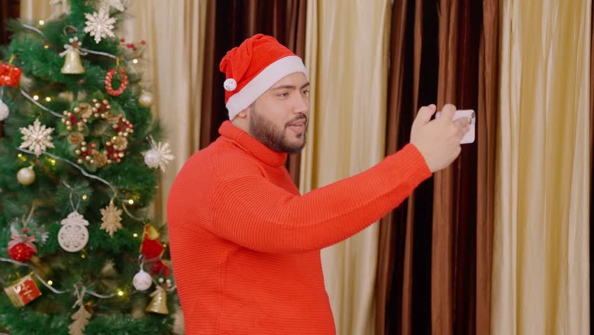 Indian Man Vlogging on Christmas with Christmas Tree in background