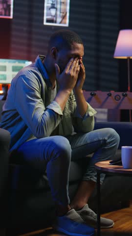 Vertical Video Stressed young adult fearing failure and struggling with deadlines, working under pressure and stress from superiors. Frustrated worried employee making mistakes, burnout and tension