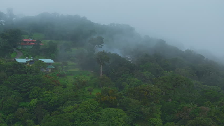 Experience stunning aerial views of misty forests and vibrant landscapes in Costa Rica. Discover serene homes nestled within the captivating fogladen beauty of this incredible destination