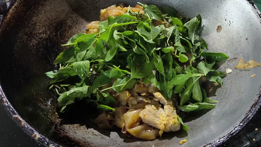 Frying noodles with basils in pan, in door  Chiangmai  Thailand.