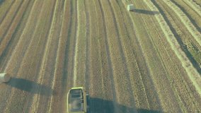 Yellow combine harvester moving over parallel harvested rows, overlaying data icons in flat design. Agriculture, data, technology, analytics, rural, machinery, precision - Powered by Shutterstock - Get 15% off with code: PIKWIZARD15