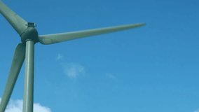 Wind turbine rotating in clear sky, floating social media metrics showing likes comments and views. Renewable energy, sustainability, digital engagement, eco-friendly, environmental technology, - Powered by Shutterstock - Get 15% off with code: PIKWIZARD15