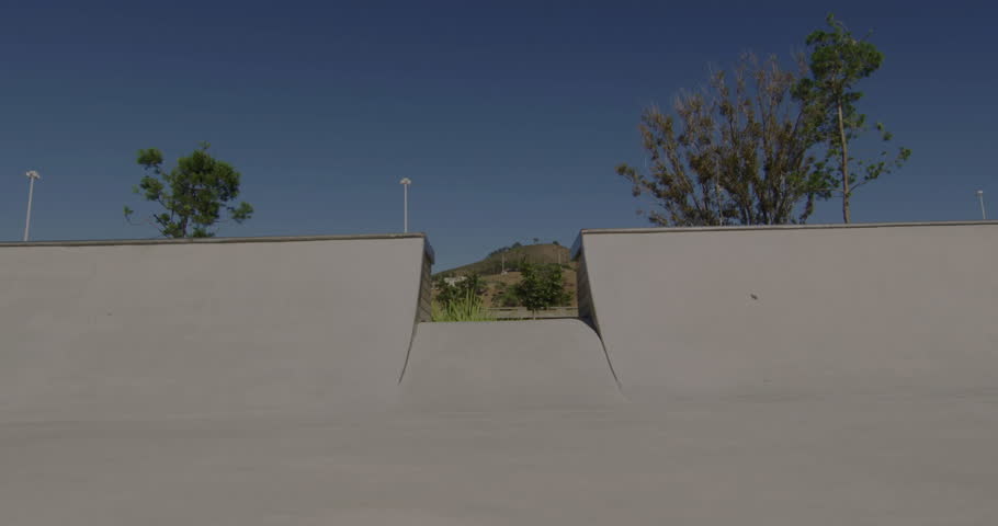 Man performing skateboard trick in skate park, showing neon circle overlay for tech demo. Adventure, urban, vibrant, dynamic, motion, youth, streetwear