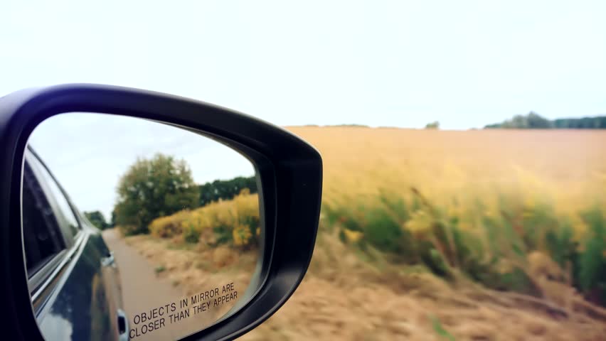 Driver Side Car Mirror Reflection. Vehicle Travel Trip. Rearview Mirror Car. Reflection Car Wing Mirror View. Auto Window View Driver Driving. Travelling Vacation Road Trip Adventure Transportation