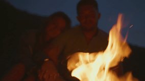 Couple enjoying a warm campfire under the night sky. - Powered by Shutterstock - Get 15% off with code: PIKWIZARD15