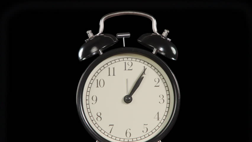 Time to Make a Great Money. The hands of the clock rotate rapidly on the dial. Exactly at 12 o'clock the alarm clock starts ringing. Behind him, against a black background, banknotes begin to slowly f