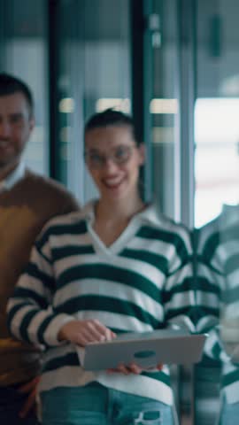 A diverse multiethnic business team of entrepreneurs and leaders in a modern office collaborating in an open space. Their teamwork, motivation, and partnership fuel the company's growth and success