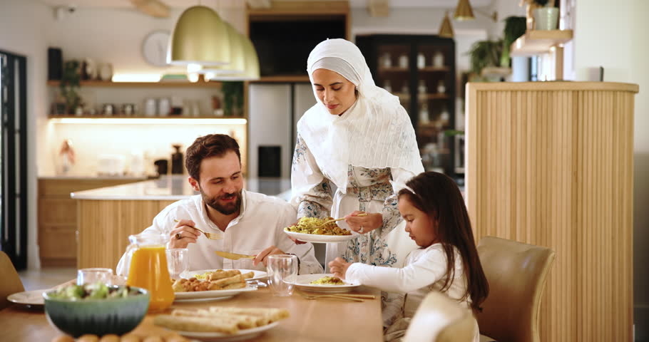 Muslim mom, kid or dad with food for serving lunch for healthy meal, care or love for diet in home. Islamic family, father or child eating for brunch, giving or feast with snack, mother or support