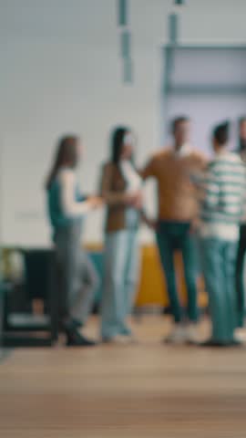 A diverse, multiethnic business team of entrepreneurs and leaders in a modern office, collaborating in an open space. Their teamwork, motivation, and partnership fuel the company's growth and success