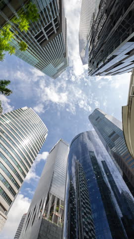 wide angle timelapse looking up of the singapore central business district skyline in vertical