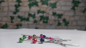 timelapse of safety pin on white background being lifted by magnet - Powered by Shutterstock - Get 15% off with code: PIKWIZARD15