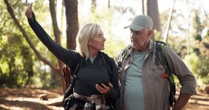 Phone, hiking and couple in forest for direction, destination discussion or lost in woods. Mobile, senior man and woman trekking, reading map or pointing for navigation app with location for travel - Powered by Shutterstock - Get 15% off with code: PIKWIZARD15