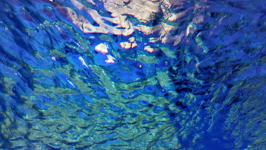 The underwater scenes of the blue sea shines with reflective light from the sun.