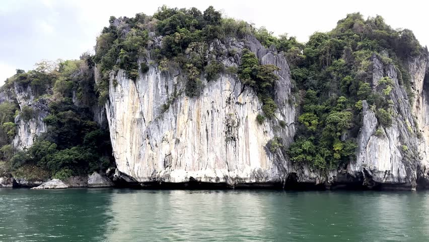 Beautiful Exploring the magnificent scenery of clear blue water surrounded by high cliffs in El Nido, Palawan.	