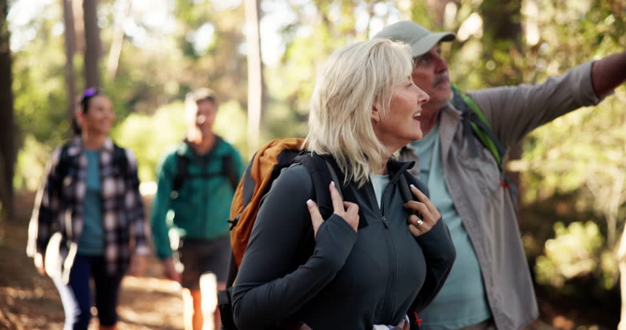 Hiking, woman and group in woods, walking and journey for backpacking in environment and adventure. Outdoor, trekking and traveller on holiday in nature, forest and people on trip for exploration