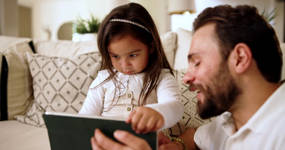 Home, game and dad with child for tablet, support and education app for cognitive development. Couch, laugh and father with girl for digital streaming, learning website and bonding together in house