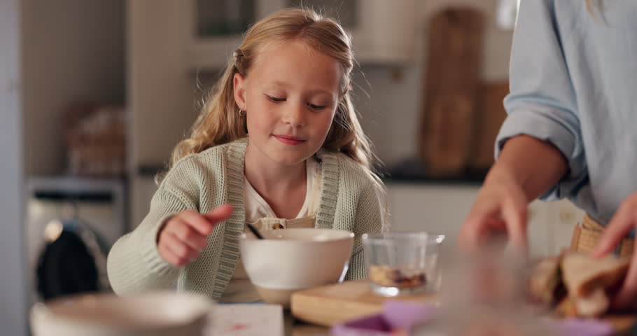 Hands, child and parent packing lunch box in home with sandwich, breakfast and food for back to school. Morning, guardian and girl eating in kitchen for bread, snack and meal for nutrition or care