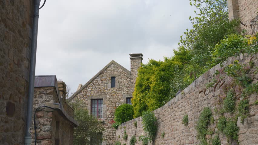 View of the medieval stone buildings on the island of Mont-Saint-Michel in Normandy, in the department of Manche, France.