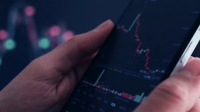 Close-up of fingers interacting with a smartphone displaying a dynamic financial chart with red and green candlesticks, set against a blurred background of more market data.  mobile trading analysis - Powered by Shutterstock - Get 15% off with code: PIKWIZARD15