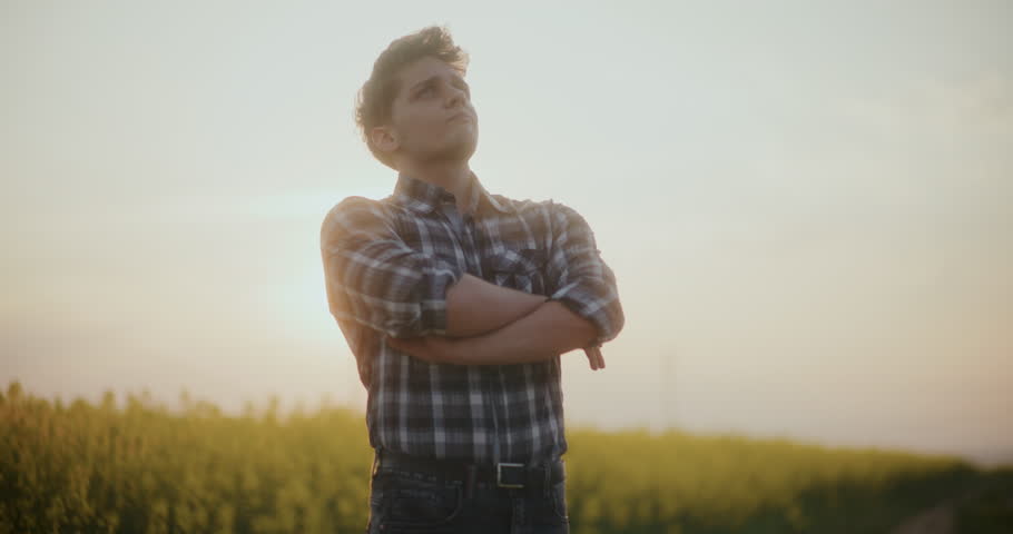 An anxious farmer looks up at the sky, seeking inspiration and contemplating a better future.