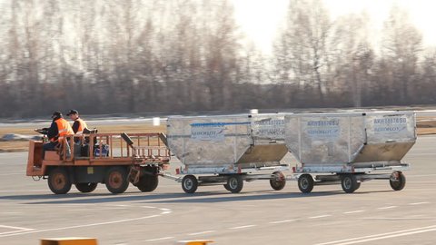 UFA, RUSSIA - APRIL 16: The unloading luggage from the plane. Ufa Airport in April, 2013 in UFA, Russia