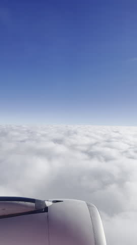 view from a plane window of the sky with the wing shot in vertical