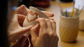 Couple hands painting together romantic date in pottery workshop family woman man girl guy artist drawing love symbol on clay cup ceramics modeling design artwork handmade crafting loving heart paint - Powered by Shutterstock - Get 15% off with code: PIKWIZARD15