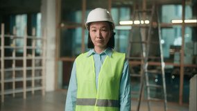 Asian woman in vest hard hat safety construction Chinese Korean girl Japanese female professional engineer architect foreman builder developer showing thumb up gesture approval building work industry - Powered by Shutterstock - Get 15% off with code: PIKWIZARD15