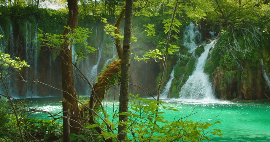 Cascading waterfalls in vibrant green surroundings and blue water in Plitvice Lakes National Park Croatia