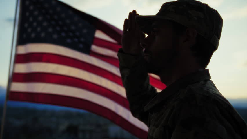 Silhouette Of A Soldier Salutes In Front American Flag At Sunset Memorial Day