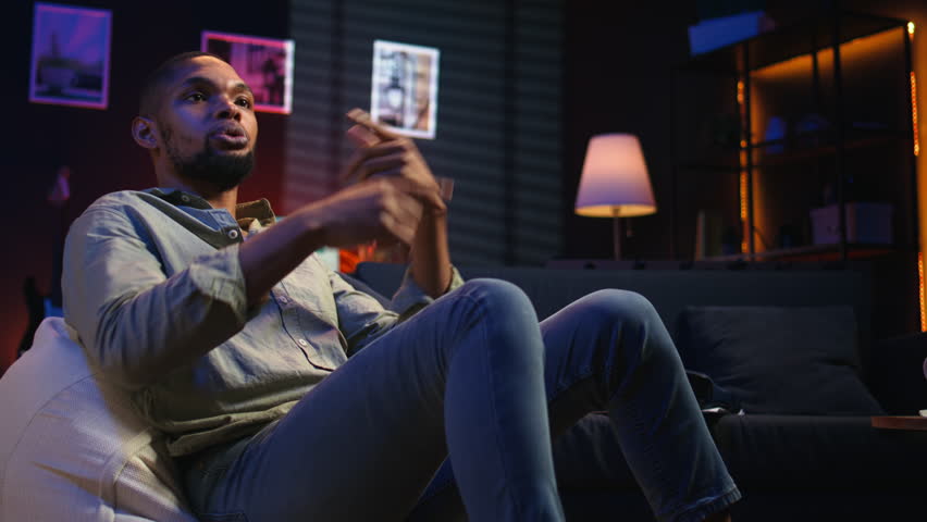 Young adult attending an online class via video conference on internet, meeting with a teacher for important virtual lesson. Black guy studying hard for his master degree remotely. Camera A.