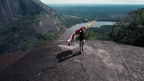 Traveler with Colombian Flag on Top of Cerros de Mavicure - Guainía, Colombia - Powered by Shutterstock - Get 15% off with code: PIKWIZARD15