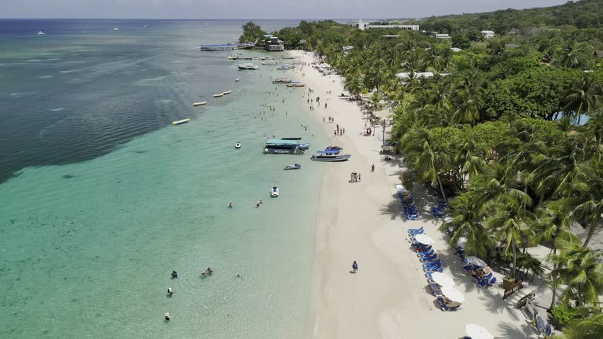 Drone hovers, and then slowly lowers over West Bay beach in Roatán, Honduras