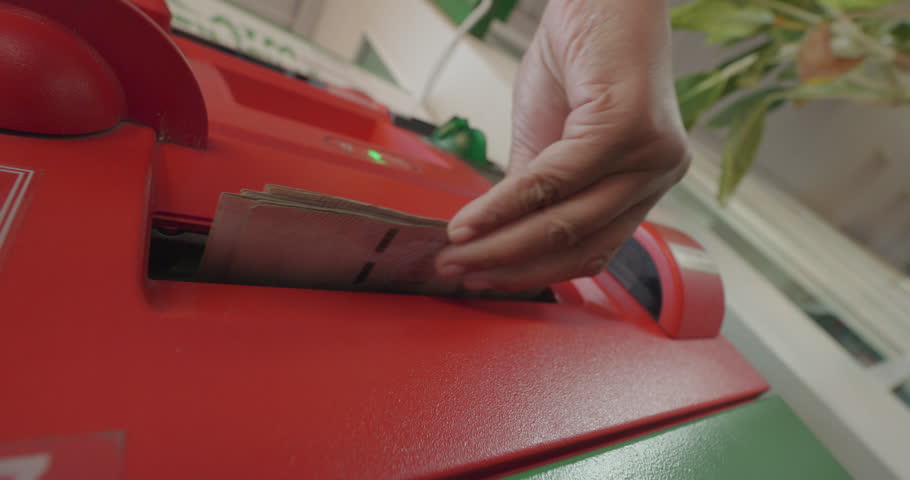 Woman withdraw cash from ATM.
